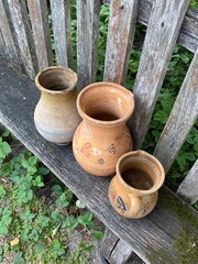 Antique clay pots on a village bench