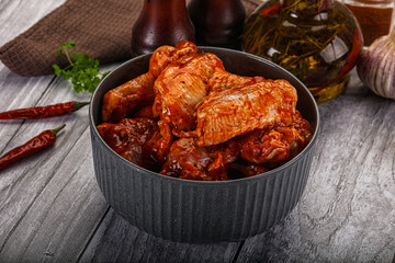 Raw marinated buffalo chicken wings