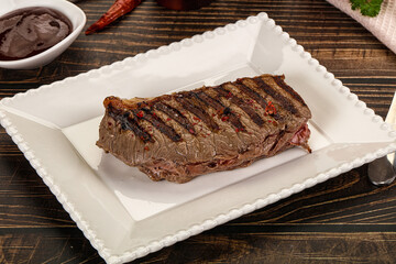 Grilled beef striploin steak with sauce