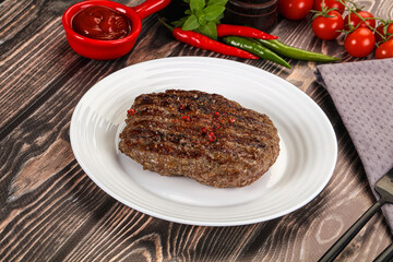 Grilled beef burger cutlet with sauce