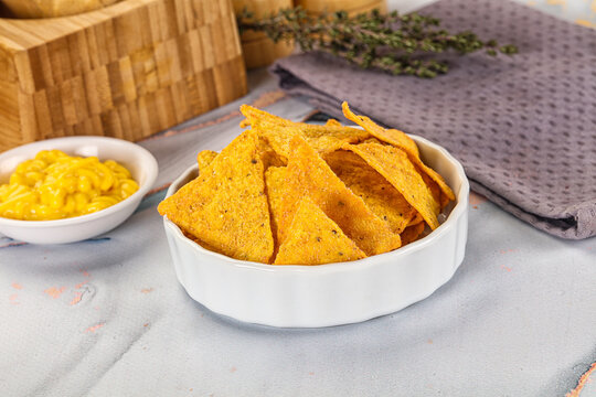 Corn nachos chips with cheese dip - Powered by Adobe