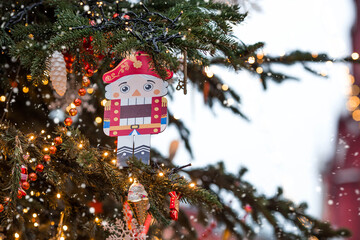 Festive toys and a nutcracker on a Christmas tree in Moscow. New Year's card 2026. Beautiful...
