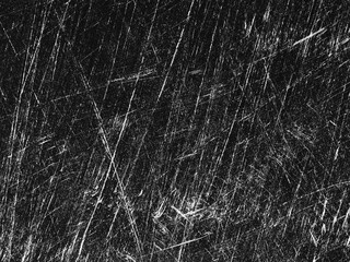 Texture of scratched surface reveals intricate line patterns in black and white