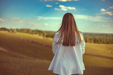 Carefree woman enjoying summer sunny day and breathing fresh air.