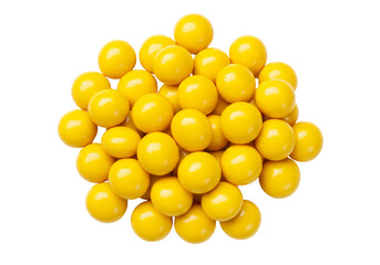 Fototapeta premium A small pile of bright yellow, round candy-coated chocolates or candies, white background isolated