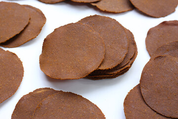 Fermented soybean discs, known as “Thua Nao,” a traditional Thai seasoning used to enhance...
