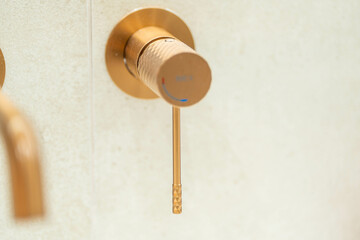 Brushed gold shower mixer with knurled handle — minimalist luxury bathroom fixture, elegant matte...