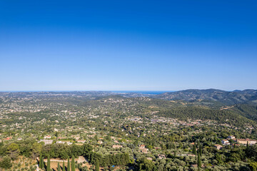 Obraz premium Panoramic aerial view of the French Riviera hills and coastline under clear blue sky, South of France summer landscape