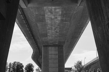 Exploring the intricate beauty of a modern underpass amidst lush greenery on a bright day