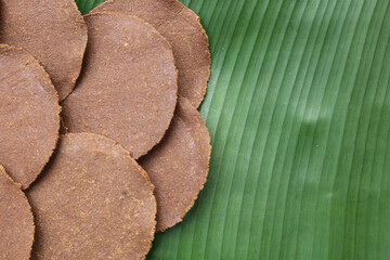 Fermented soybean discs, known as “Thua Nao,” a traditional Thai seasoning used to enhance...