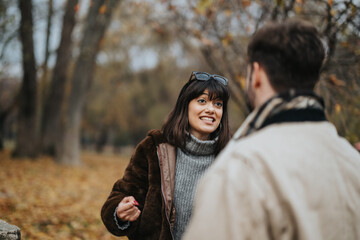 A joyful moment highlighting social interaction between individuals amidst the vibrant autumn...