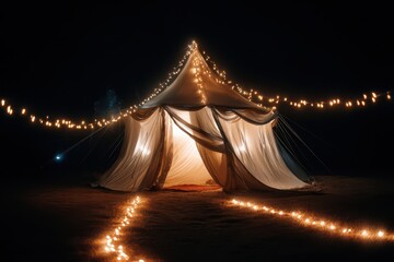 Large event tent glowing at night with string lights illuminating path