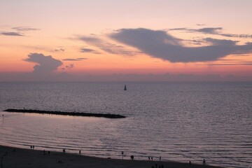 Sunset over the Mediterranean Sea with a Distant Sailboat
