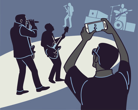 Live music concert silhouettes with a fan capturing photo on their smartphone