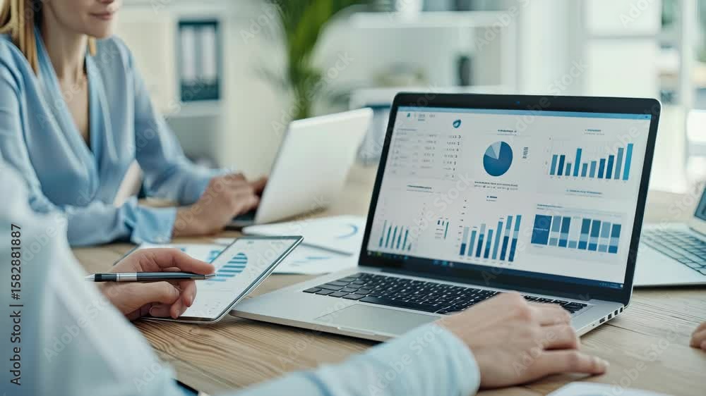 Poster team collaborates on analysis of performance metrics and data visualizations to improve business str