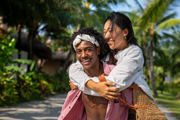Romantic interracial couple enjoying a tropical honeymoon on a beach, embracing love and happiness