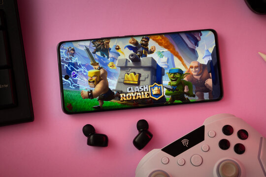 Dhaka, Bangladesh- 15 July 2025: A close-up of a gamepad with the Clash Royale seen on smartphone.