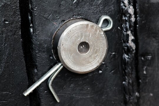 cotter pin holding a shaft in machinery, cotter pin through the end of a pin. Industrial concept.