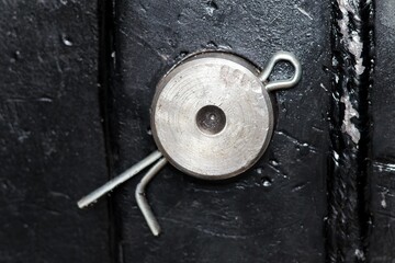cotter pin holding a shaft in machinery, cotter pin through the end of a pin. Industrial concept.