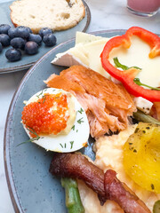 Gourmet Breakfast Plate with Salmon, Cheese, Asparagus, Egg, Bacon, fruits and Vegetables