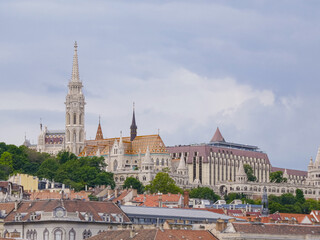 Colorful tiled roof of Matthias Church and white towers of Fisherman's Bastion in Budapest under...