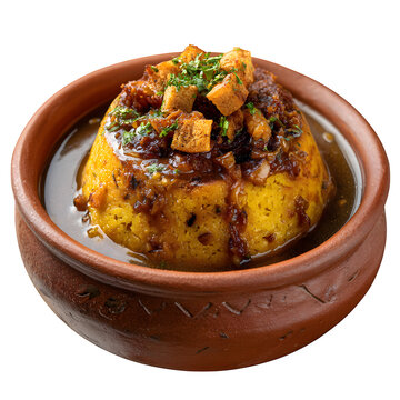 Puerto Rican mofongo with garlic, pork cracklings, and gravy in a pil?n bowl, isolated on a white background