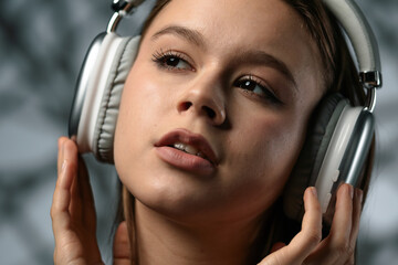 Young Woman Enjoying Music Through Over Ear Headphones