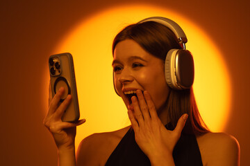 Woman with Wireless Headphones Enjoying a Video Call on Smartphone