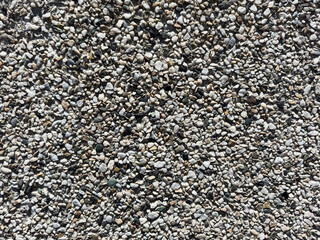 Small stones background, small stones, textured wall. There are some small holes in the wall