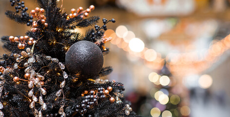 Stylish Christmas background. Black Christmas tree decorations on a Christmas tree. Concept of...