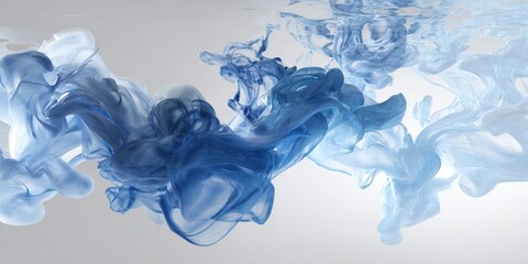 Photo of abstract swirls of blue ink gracefully mingle in water, creating a dynamic and artistic visual effect that evokes a sense of fluid motion