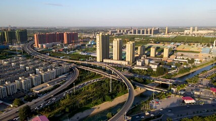 Traffic flow and infrastructure on Shijiazhuang Northeast Second Ring Road overpass during daylight - Powered by Adobe