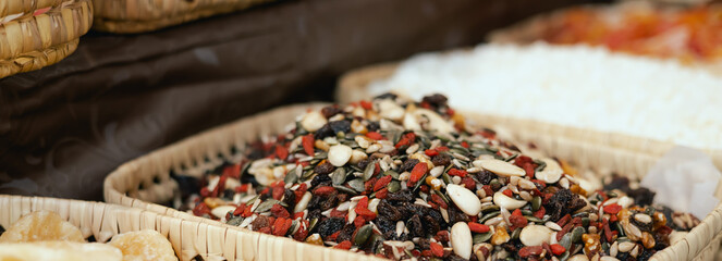 Dried fruit on sale at outdoor farmer market. The fruit shrinks during this process, leaving a...