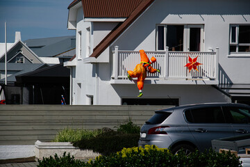 Colorful decor on a balcony in Akranes, Iceland during a sunny afternoon