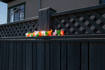 Lattice fence with Irish-themed decoration under sunlight in Akranes, Iceland