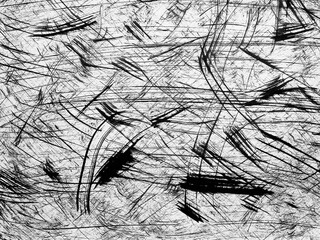 Abstract black and white texture with dynamic lines and strokes created by various materials on a...