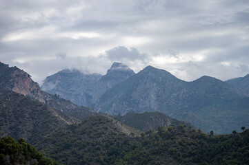 Scenic view of surrounding mountains and picturesque village from a hiking trail along an old...