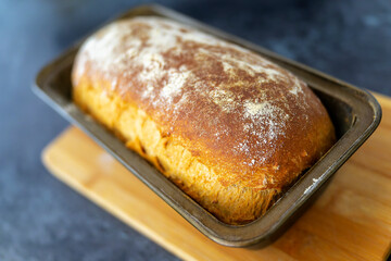 Homemade bread freshly baked in baking tin, just out of the oven.