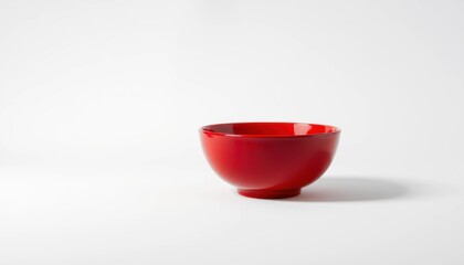 Red ceramic bowl isolated on white background with soft shadow