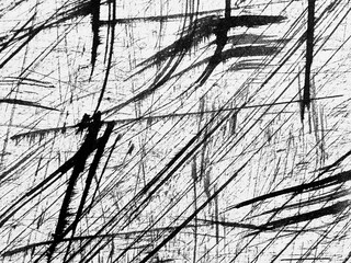 Abstract black and white texture with strong linear patterns created by scratching on a white...