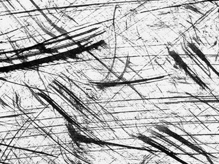 Abstract texture with black lines and scratches on a white background showing dynamic movement