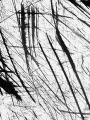 Abstract black and white pattern created by sharp lines on a textured surface