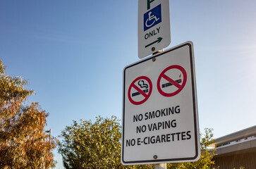 A health and safety sign in Australia prohibiting smoking, vaping, and e-cigarettes in a car park...