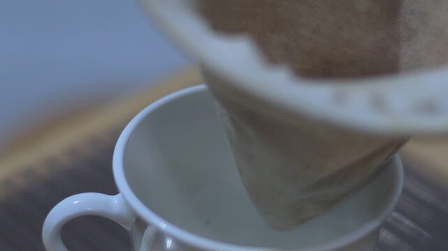 Boil water, add ground coffee to the cloth strainer, and then pour hot water over coffee, allowing you to filter