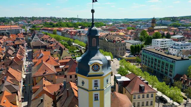4K Aerial Drone Video of the Historic Herrieder Clock Tower in the Old Town area of Downtown Ansbach, Germany