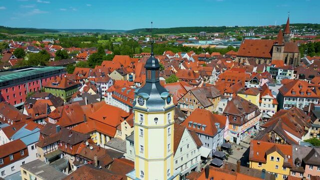 4K Aerial Drone Video of the Historic Herrieder Clock Tower and the St. Johannis Church in the Old Town area of Downtown Ansbach, Germany