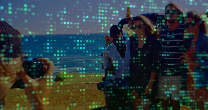 Photographer tapping shutter capturing friends raising bottles bluff while tech overlay flickering