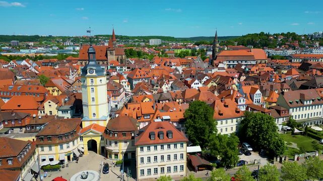 4K Aerial Drone Video of the Historic Herrieder Clock Tower, St. Johannis Church, and St. Gumbertus Church in the Old Town area of Downtown Ansbach, Germany