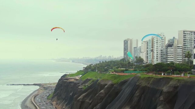 Paragliders soaring over the cliffs of Miraflores, with coastal views of Lima