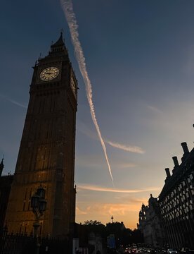 Elizabeth Tower and Big Ben clock face lit up at night in London, UK.